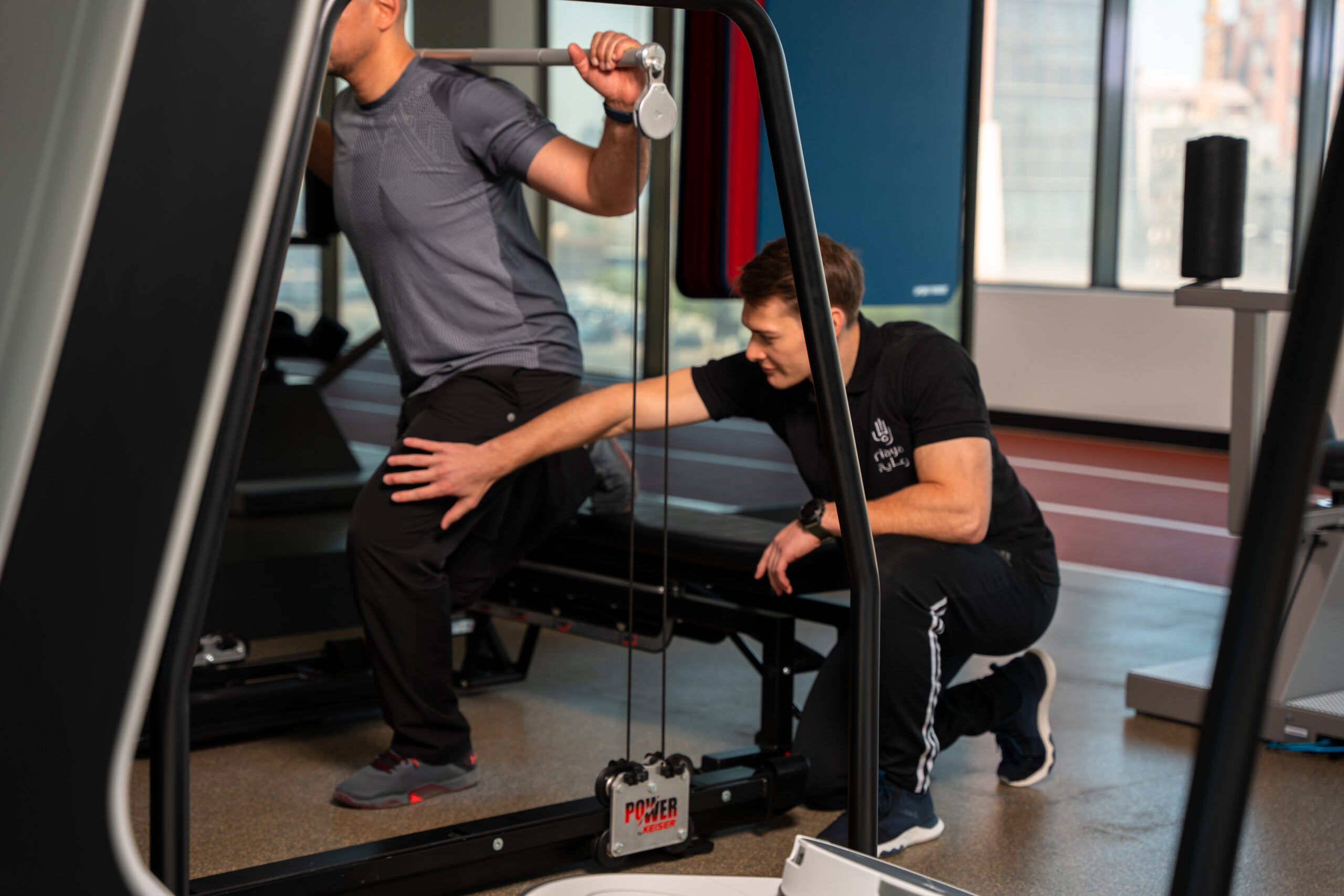 Physiotherapist coaching a patient through a strengthening exercise at ARGAN Riaya, Salmiya