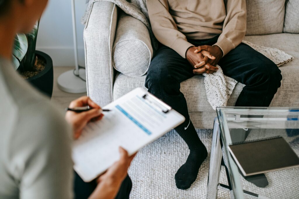 Counsellor taking notes during a conversation with a patient