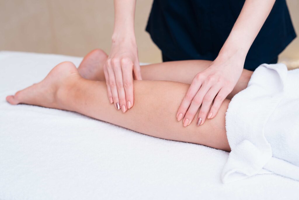 Therapist massaging a client's leg