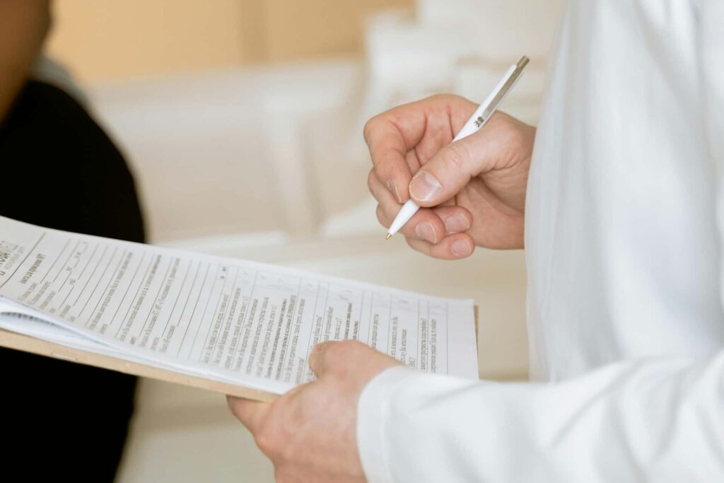 Doctor taking notes during a first consultation